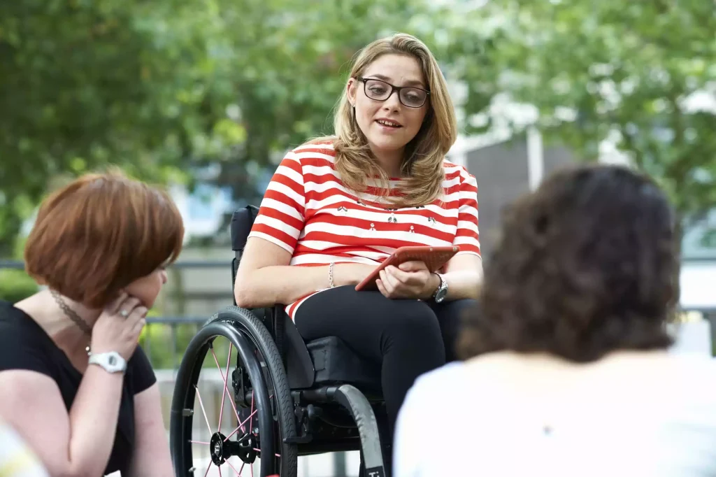 female-student-in-wheelchair-chatting-to-friends-o-2025-04-04-16-55-21-utc (1)