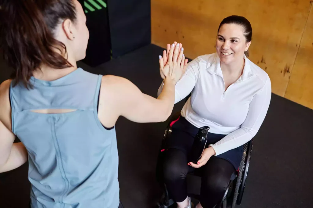 smiling-woman-with-disability-fist-bump-with-fitne-2025-03-09-17-10-50-utc (1)